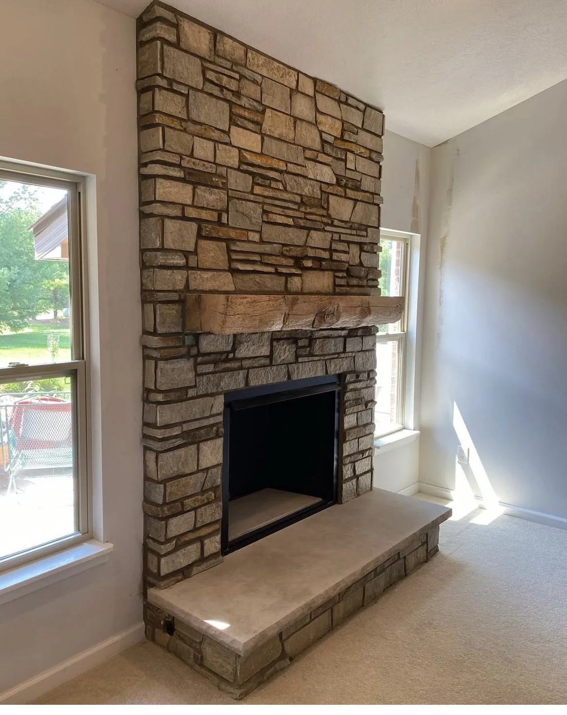 Stone surround for a linear gas fireplace